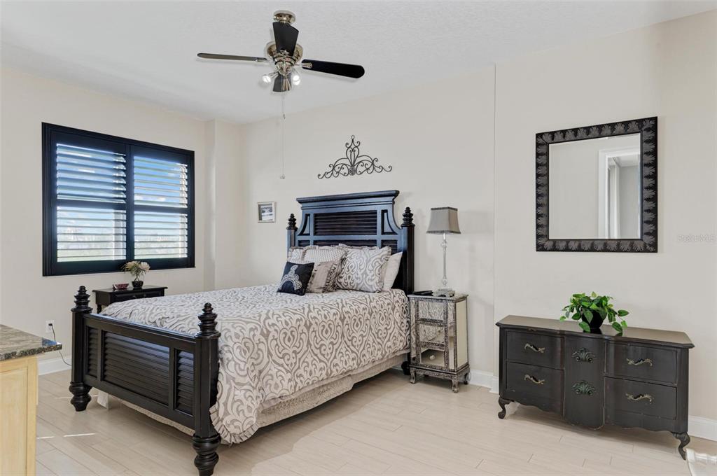 611 Riviera Dunes Way, Unit 304 Palmetto, FL 34221 - Photo 14 of 30 a bedroom with a bed dresser and a window