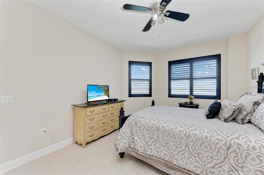611 Riviera Dunes Way, Unit 304 Palmetto, FL 34221 - Photo 15 of 30 a bedroom with a bed and a flat screen tv