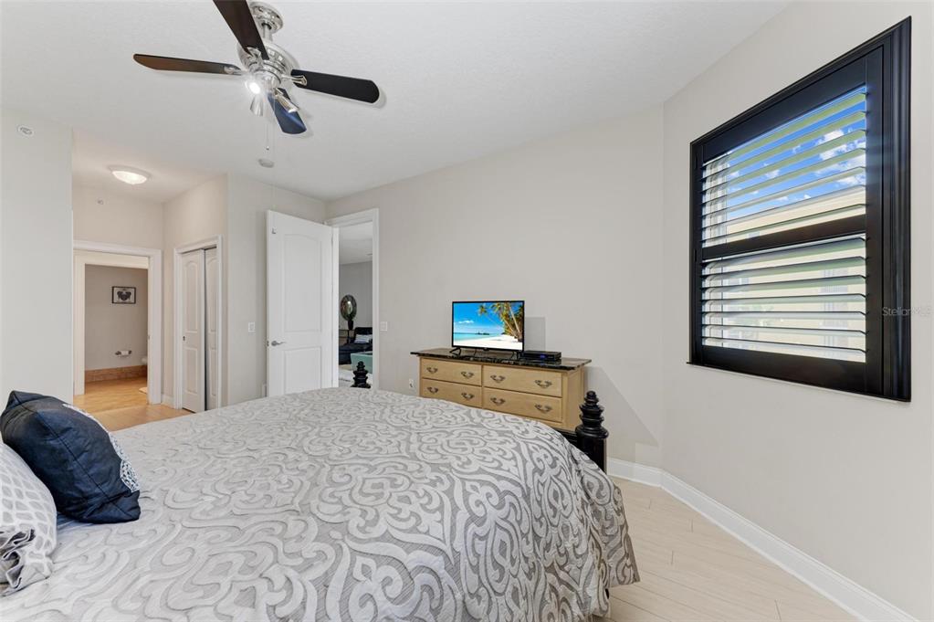 611 Riviera Dunes Way, Unit 304 Palmetto, FL 34221 - Photo 16 of 30 a bedroom with a bed and a television