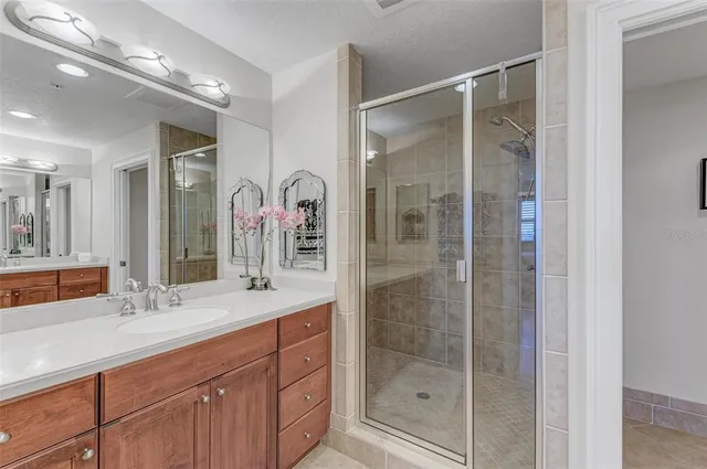 a bathroom with a shower sink and mirror