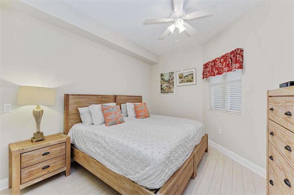 611 Riviera Dunes Way, Unit 304 Palmetto, FL 34221 - Photo 20 of 30 a bedroom with a bed and a dresser