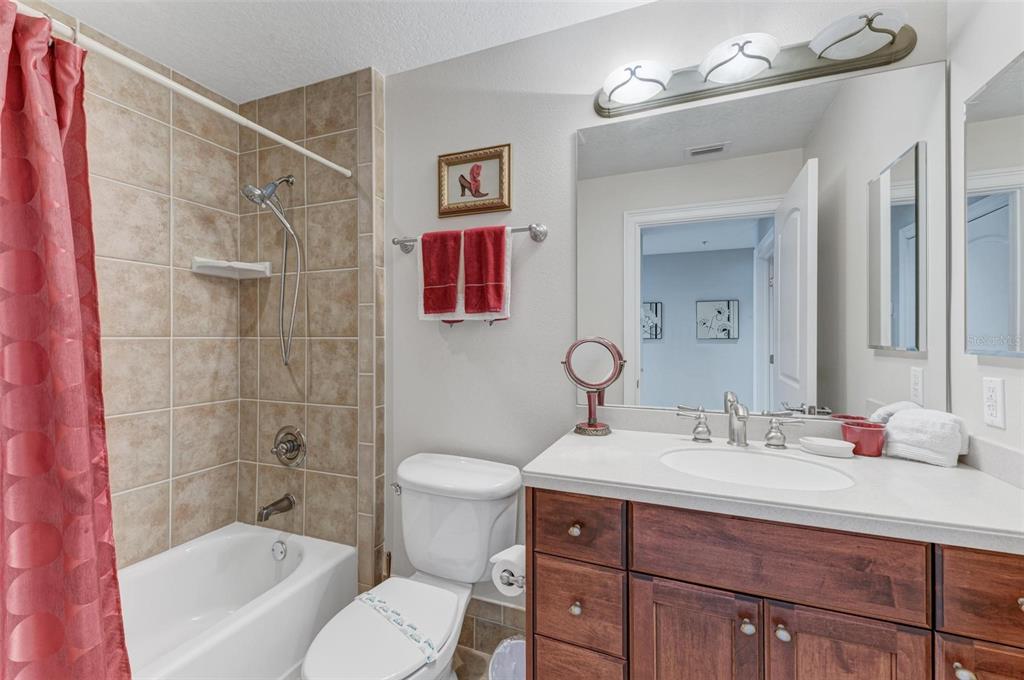 611 Riviera Dunes Way, Unit 304 Palmetto, FL 34221 - Photo 22 of 30 a bathroom with a sink vanity mirror and toilet