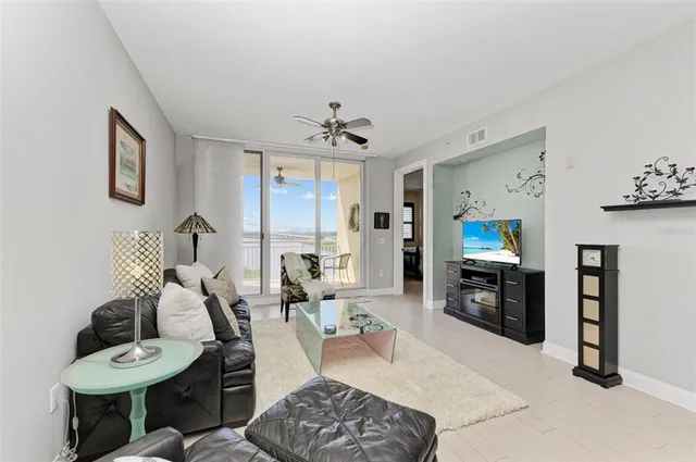 a living room with furniture a dining table and a flat screen tv