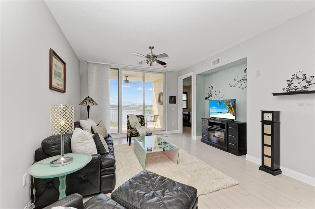 611 Riviera Dunes Way, Unit 304 Palmetto, FL 34221 - Photo 4 of 30 a living room with furniture a dining table and a flat screen tv