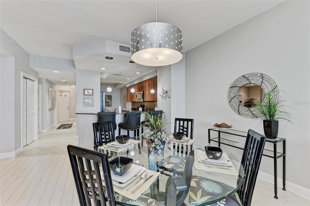 611 Riviera Dunes Way, Unit 304 Palmetto, FL 34221 - Photo 6 of 30 a view of a dining room with furniture and wooden floor