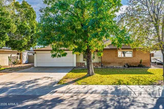a view of a yard with a house and large tree