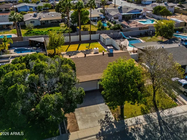 a view of an empty room and chandelier fan