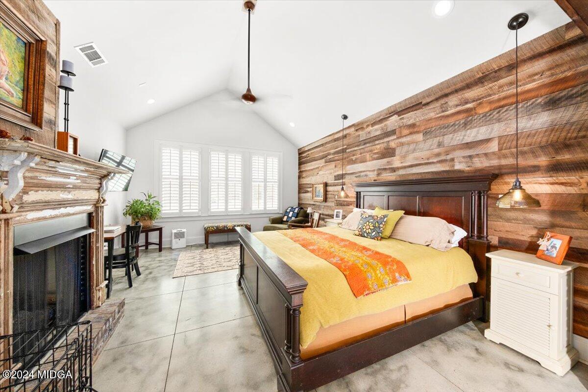 280 Joe Chambers Road Forsyth, GA 31029 - Photo 12 of 55 a bedroom with a large bed and a chandelier