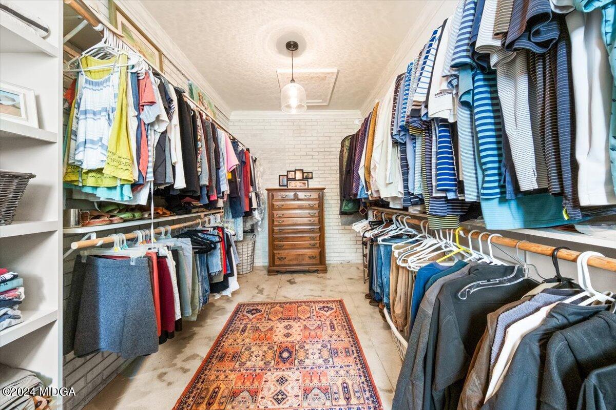 280 Joe Chambers Road Forsyth, GA 31029 - Photo 18 of 55 a view of walk in closet with clothes and shoes