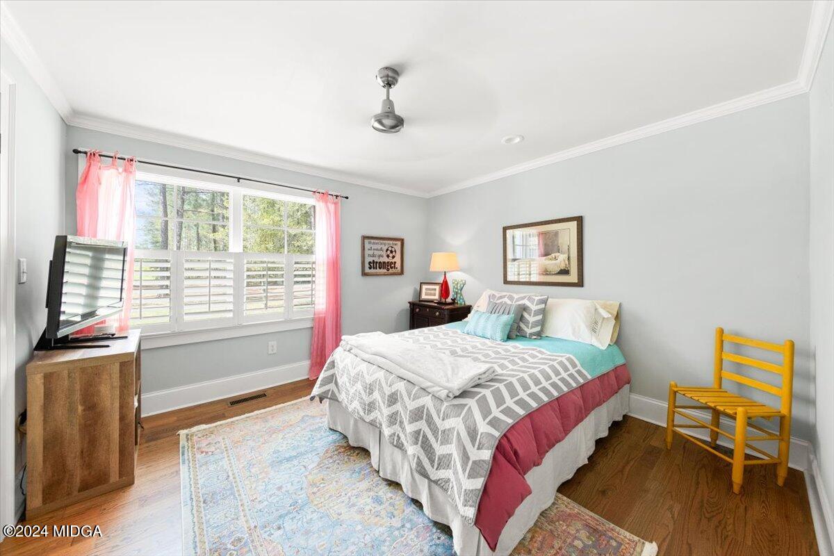 280 Joe Chambers Road Forsyth, GA 31029 - Photo 22 of 55 a bedroom with a bed and wooden floor