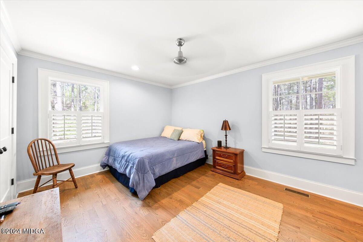 280 Joe Chambers Road Forsyth, GA 31029 - Photo 24 of 55 a bedroom with a bed and a chair