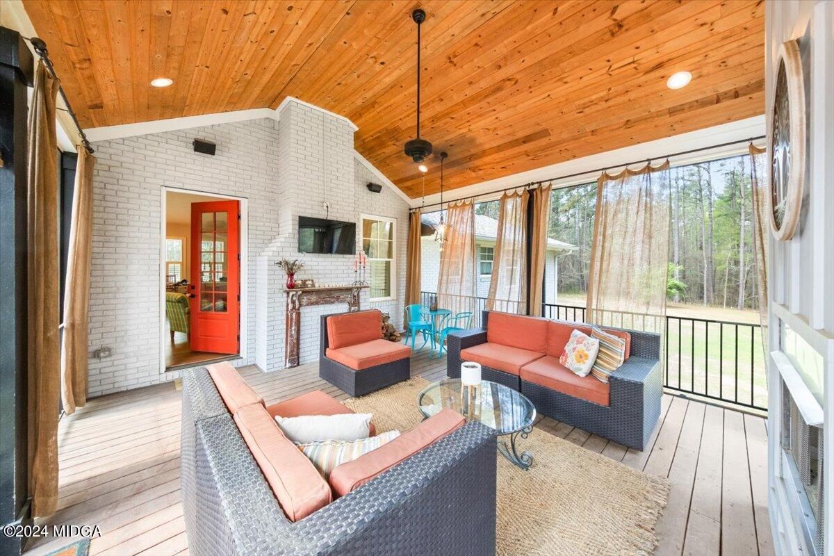 280 Joe Chambers Road Forsyth, GA 31029 - Photo 34 of 55 a outdoor living space with furniture and a fireplace