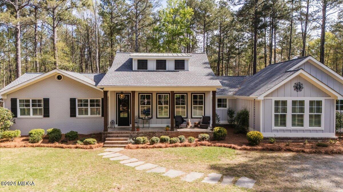 280 Joe Chambers Road Forsyth, GA 31029 - Photo 35 of 55 a front view of a house with a yard outdoor seating and covered with trees