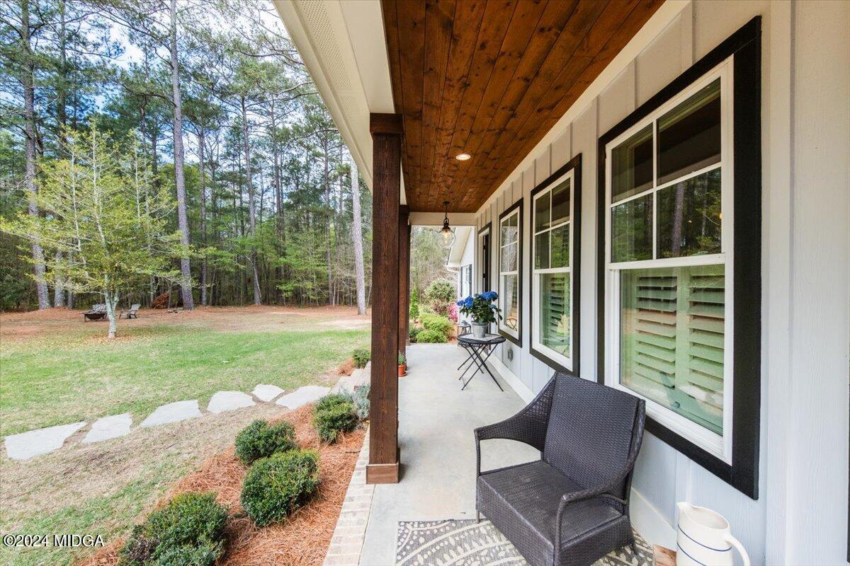 280 Joe Chambers Road Forsyth, GA 31029 - Photo 54 of 55 a view of a porch with chairs and backyard