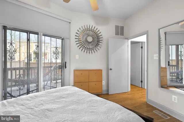 a bedroom with a bed and a large window