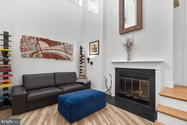a living room with furniture and a fireplace