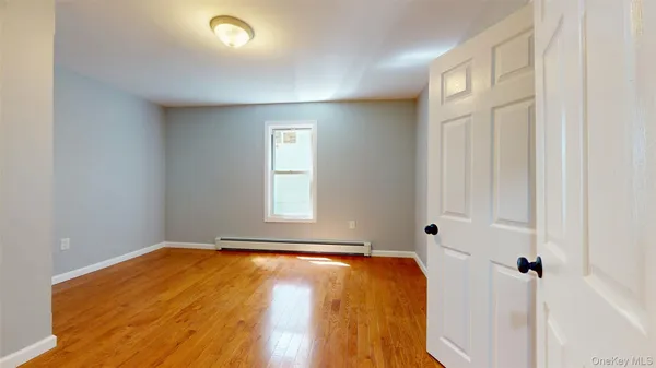 a view of a room with wooden floor and cabinet