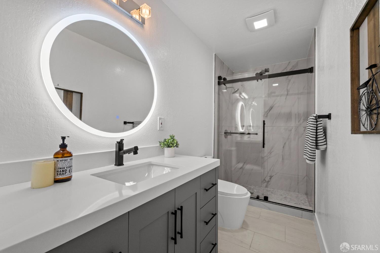 226 Rutledge Street San Francisco, CA 94110 - Photo 12 of 44 a bathroom with a sink a toilet and a mirror