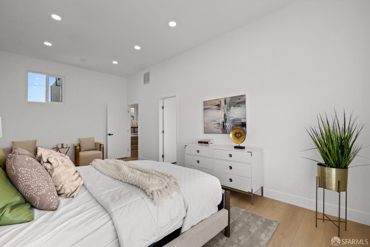 226 Rutledge Street San Francisco, CA 94110 - Photo 28 of 44 a bedroom with a bed and a potted plant