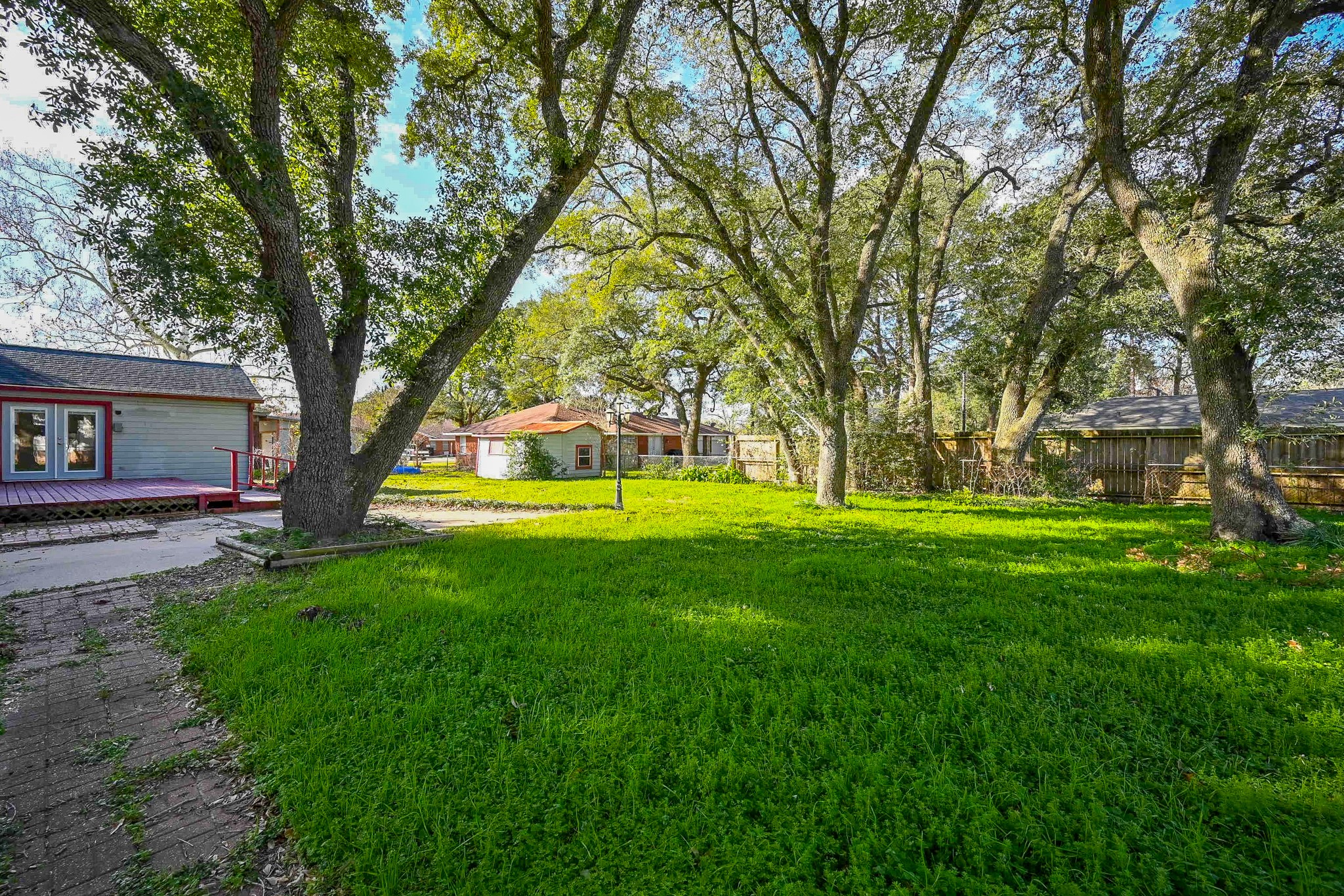 1707 Key Street Waller, TX 77484 - Photo 23 of 26 Another view of the big backyard, mature trees, large deck & patio plus storgae shed