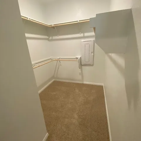 a view of walk in closet with empty racks