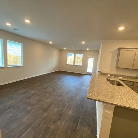 a kitchen with a sink stove and cabinets