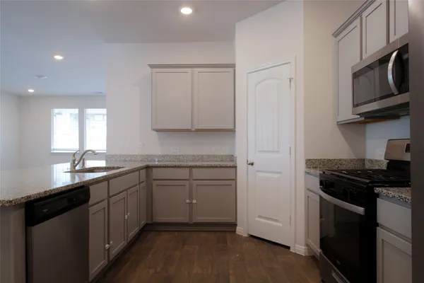 a kitchen with a refrigerator stove and microwave