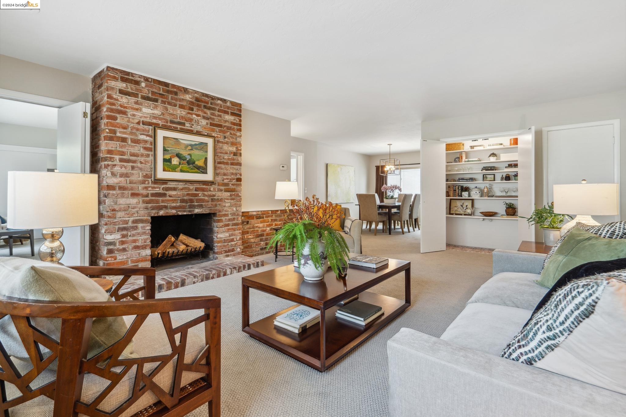 1519 Oxford Street, Unit H Berkeley, CA 94709 - Photo 1 of 1 a living room with furniture and a fireplace