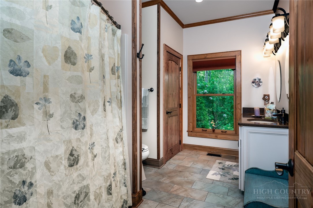 171 Camp Davis Road Banner Elk, NC 28604 - Photo 31 of 48 a bathroom with a granite countertop sink a mirror and a shower