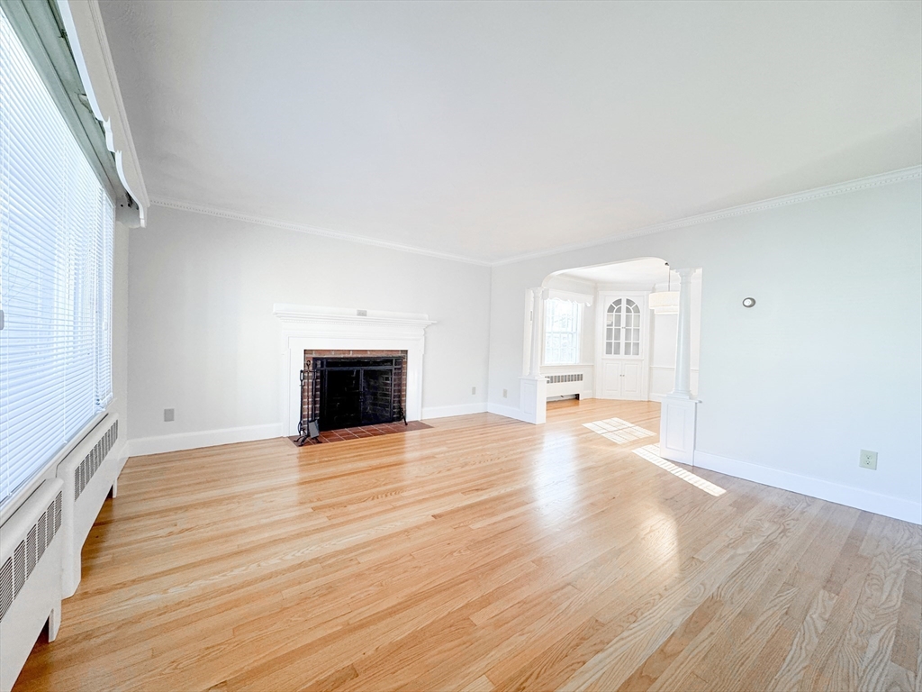 40 Walter Street, Unit 1 Lynn, MA 01902 - Photo 12 of 40 a view of empty room with wooden floor and fireplace