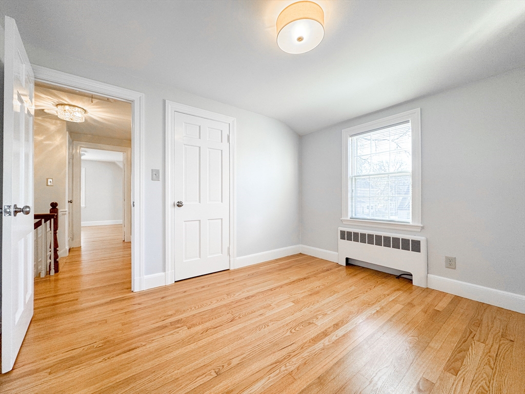 40 Walter Street, Unit 1 Lynn, MA 01902 - Photo 20 of 40 a view of an empty room with wooden floor and a window