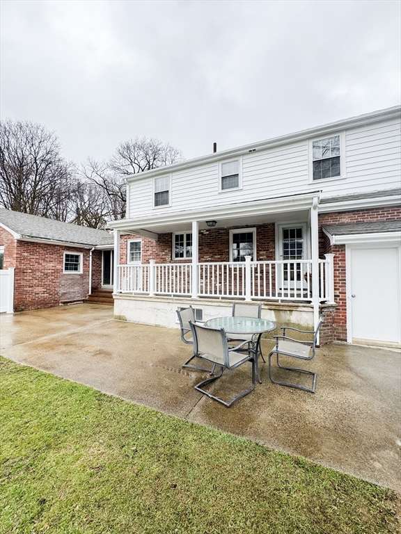 40 Walter Street, Unit 1 Lynn, MA 01902 - Photo 37 of 40 a backyard of a house with a bench and trees