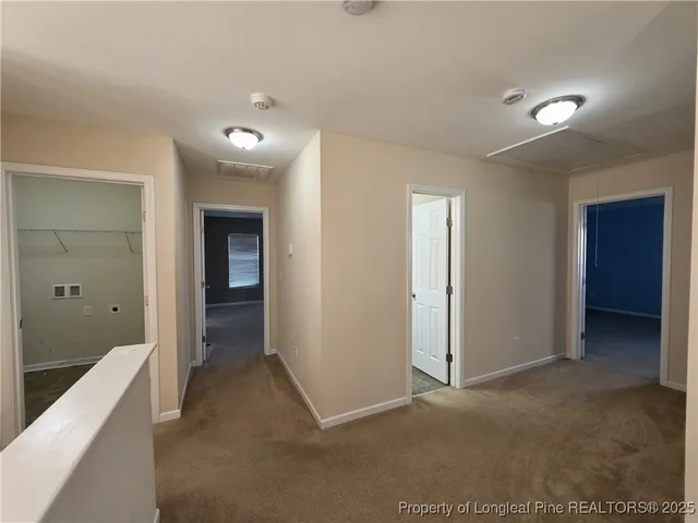 a view of empty room with windows and ceiling fan