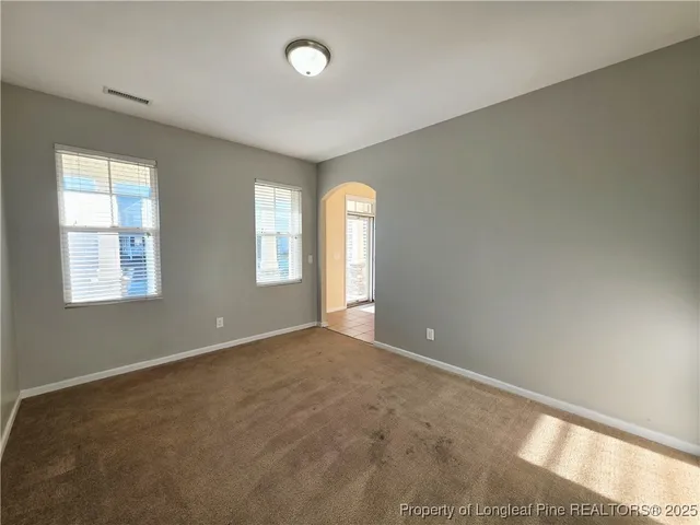 an empty room with windows and closet