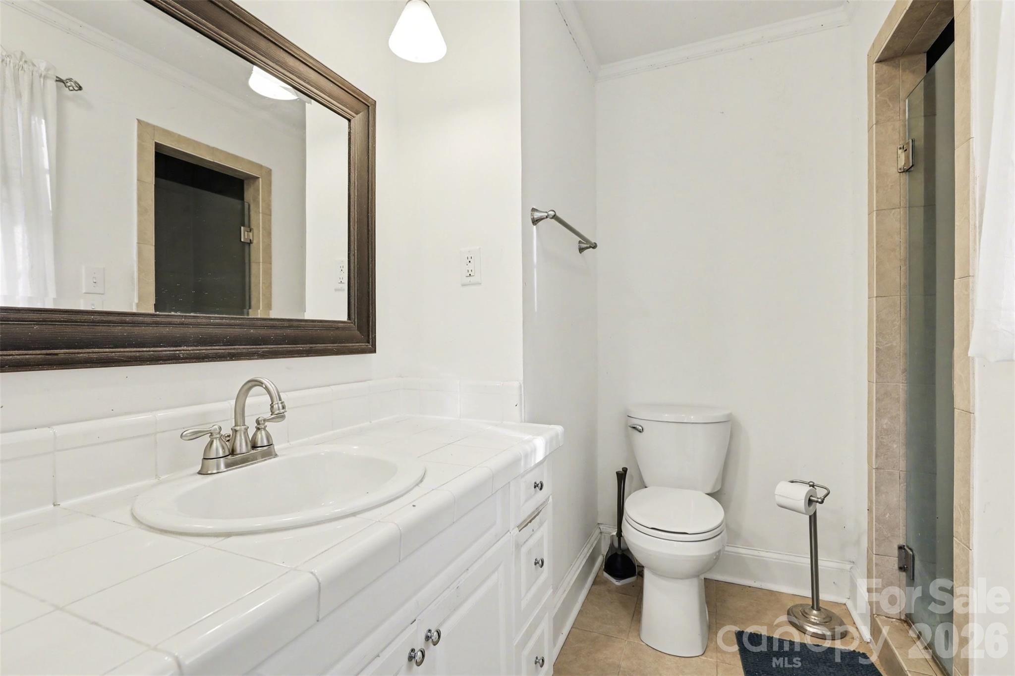 3101 Eastburn Road Charlotte, NC 28210 - Photo 27 of 31 a bathroom with a toilet sink and mirror