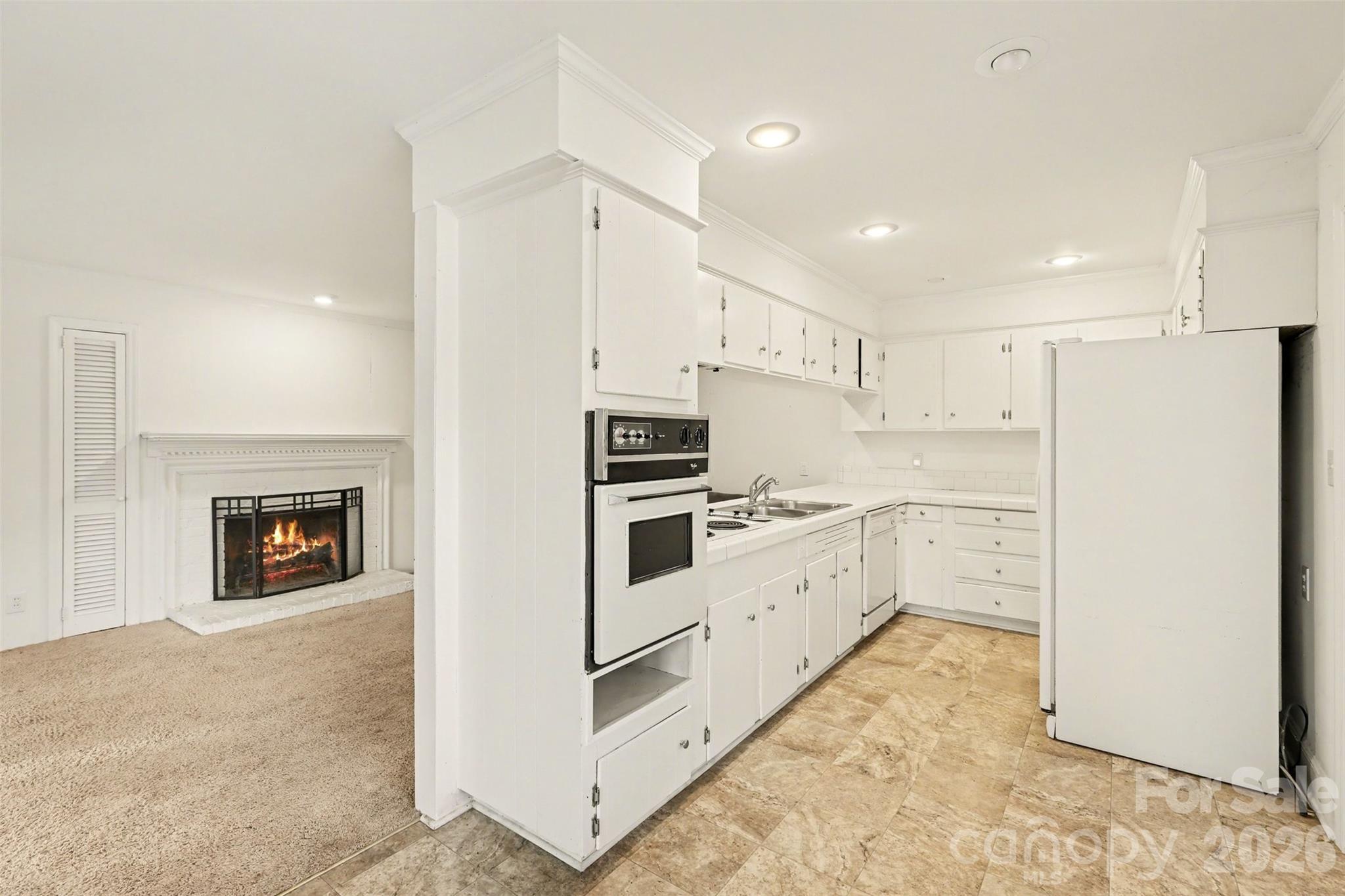 3101 Eastburn Road Charlotte, NC 28210 - Photo 8 of 31 a kitchen with granite countertop white cabinets and white appliances