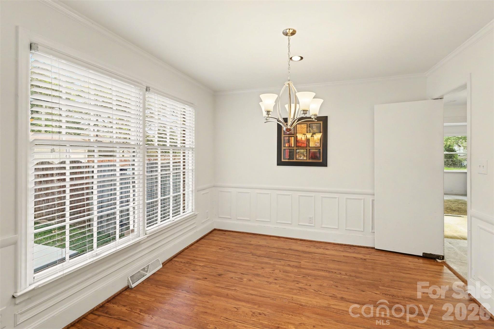 3101 Eastburn Road Charlotte, NC 28210 - Photo 10 of 31 a view of an empty room with a window and wooden floor
