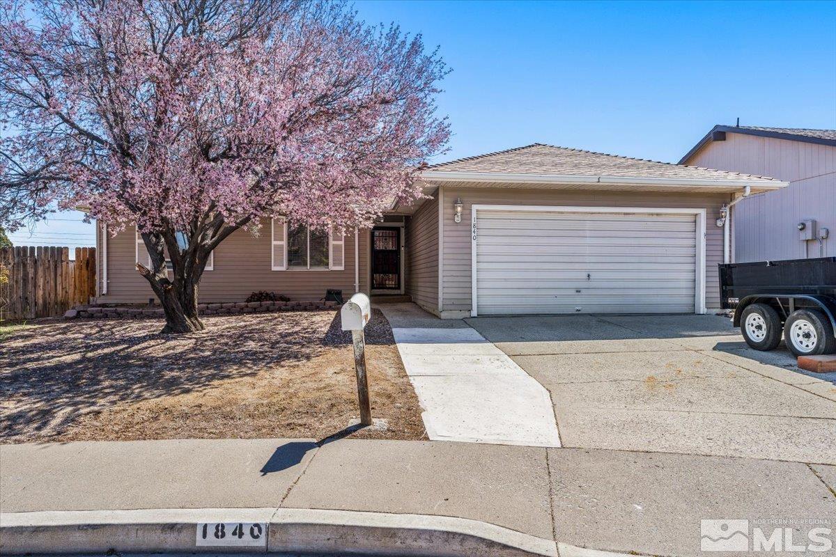 1840 Ribeiro Circle Reno, NV 89503 - Photo 3 of 32 a front view of a house with a yard and garage