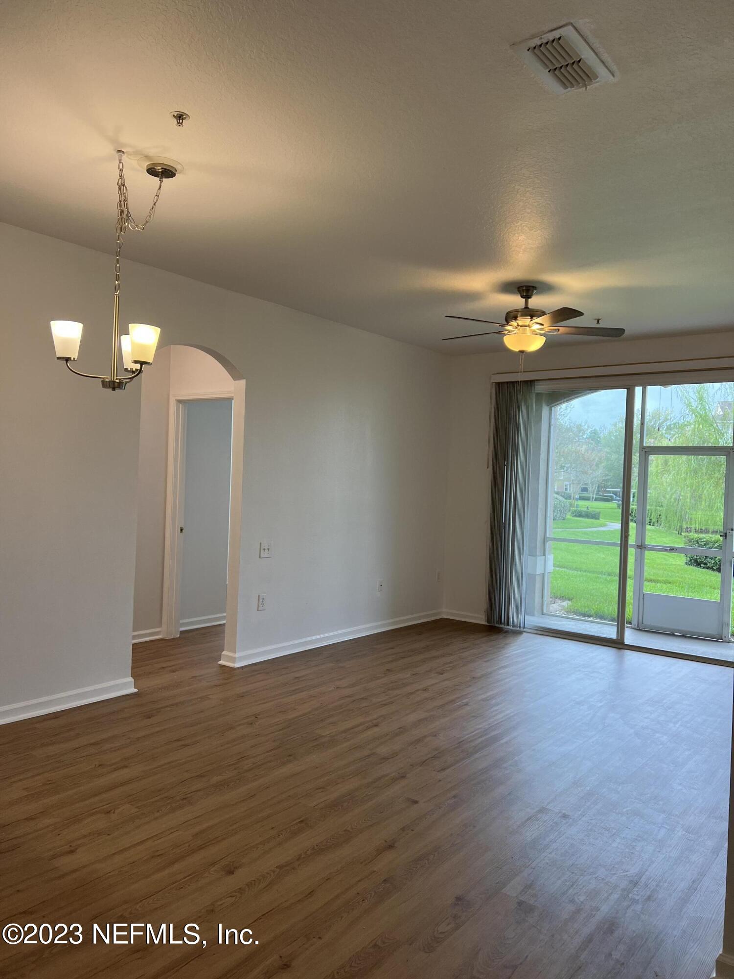 7990 Baymeadows Road East, Unit 418 Jacksonville, FL 32256 - Photo 14 of 25 an empty room with wooden floor and windows