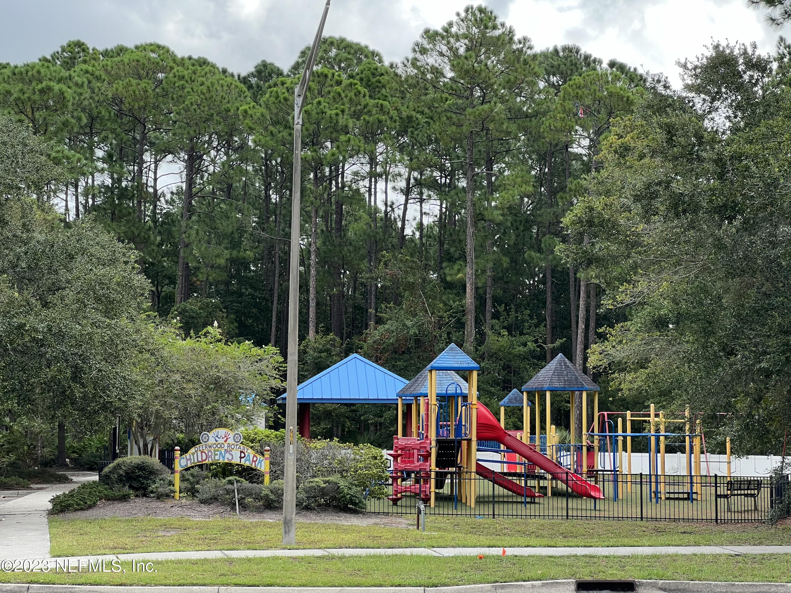 7990 Baymeadows Road East, Unit 418 Jacksonville, FL 32256 - Photo 2 of 25 a view of a park with large trees and plants