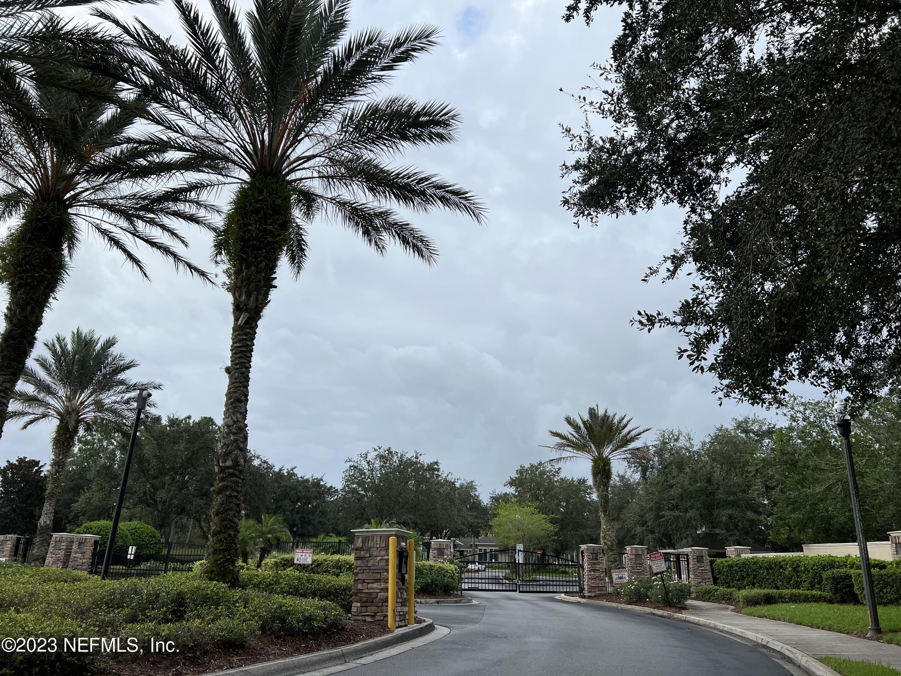 7990 Baymeadows Road East, Unit 418 Jacksonville, FL 32256 - Photo 5 of 25 a view of a yard with palm trees