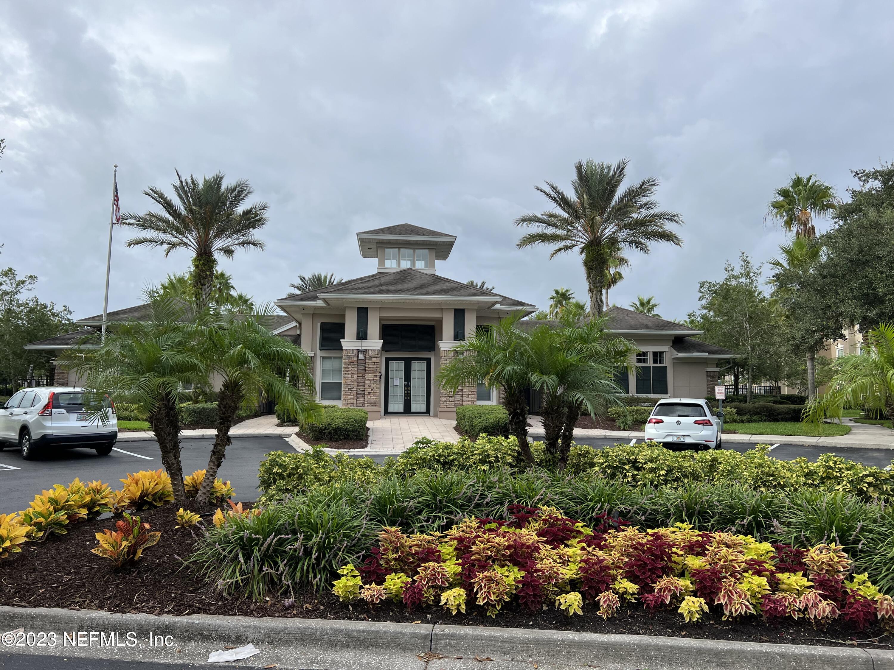 7990 Baymeadows Road East, Unit 418 Jacksonville, FL 32256 - Photo 6 of 25 a front view of a house with a yard and garden