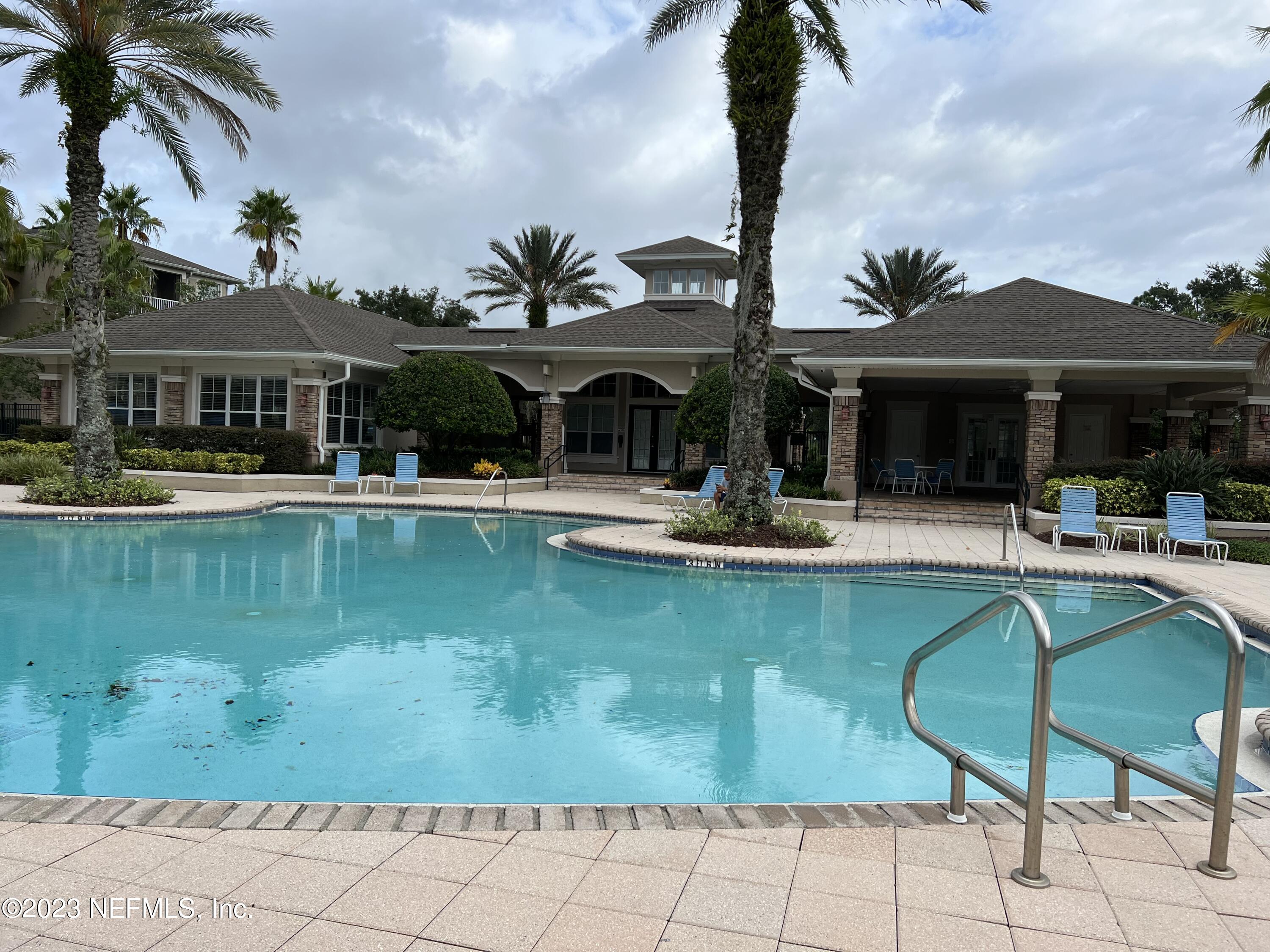 7990 Baymeadows Road East, Unit 418 Jacksonville, FL 32256 - Photo 7 of 25 a view of a patio with swimming pool table and chairs