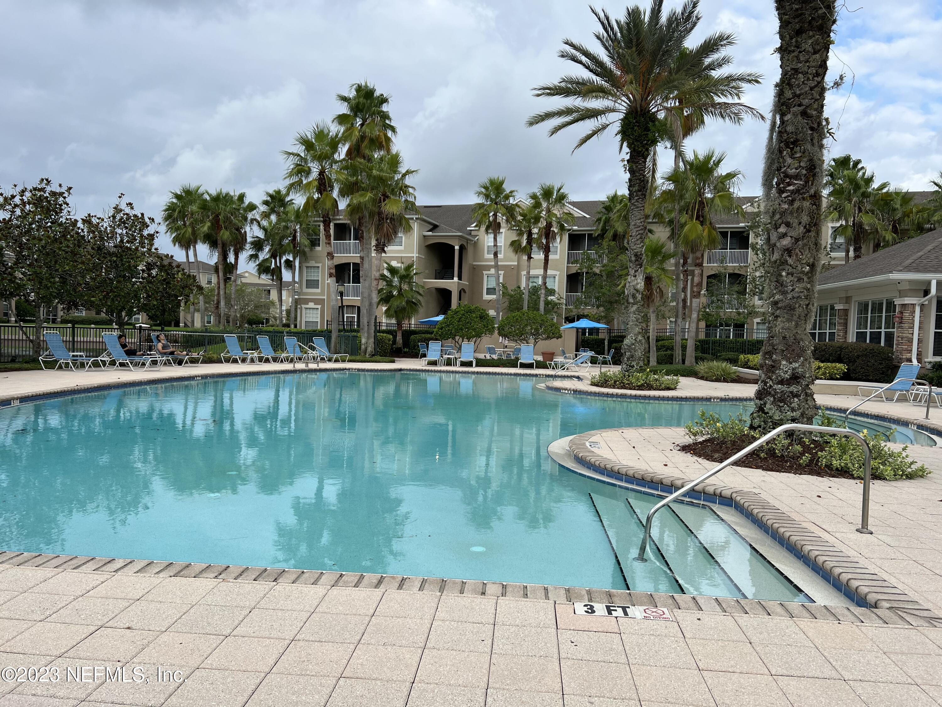 7990 Baymeadows Road East, Unit 418 Jacksonville, FL 32256 - Photo 8 of 25 a view of a lake with a yard and potted plants