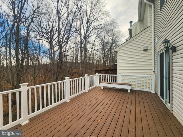 a view of deck with wooden floor and fence