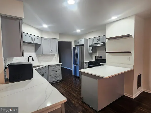 a kitchen with a sink a stove and refrigerator