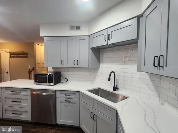 a kitchen with cabinets appliances and a sink