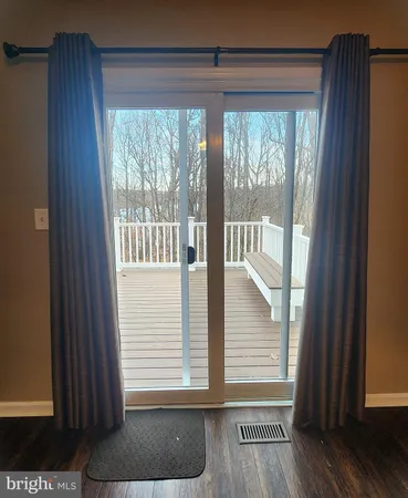 a view of wooden floor and windows in a room