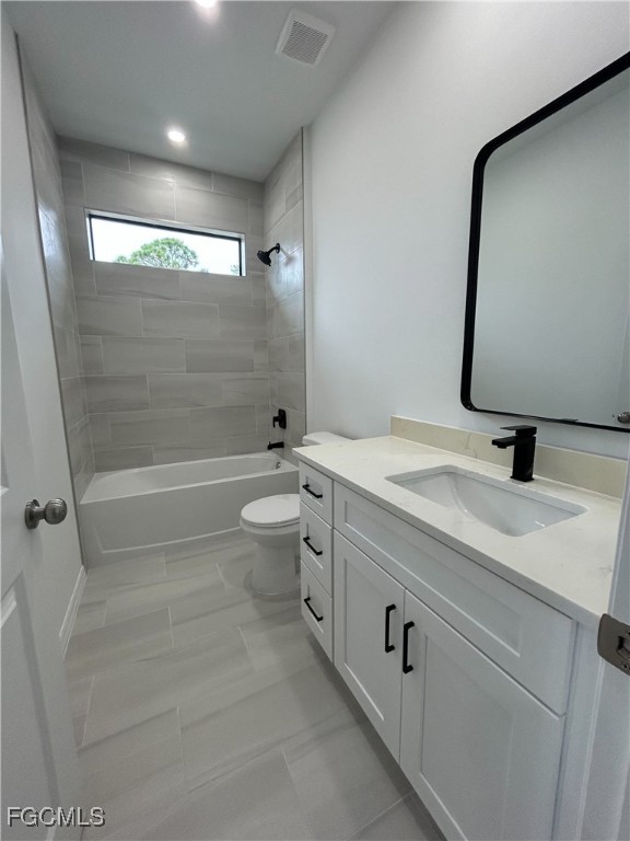 453 Bell Boulevard Lehigh Acres, FL 33974 - Photo 15 of 21 a bathroom with a double vanity sink toilet mirror and shower