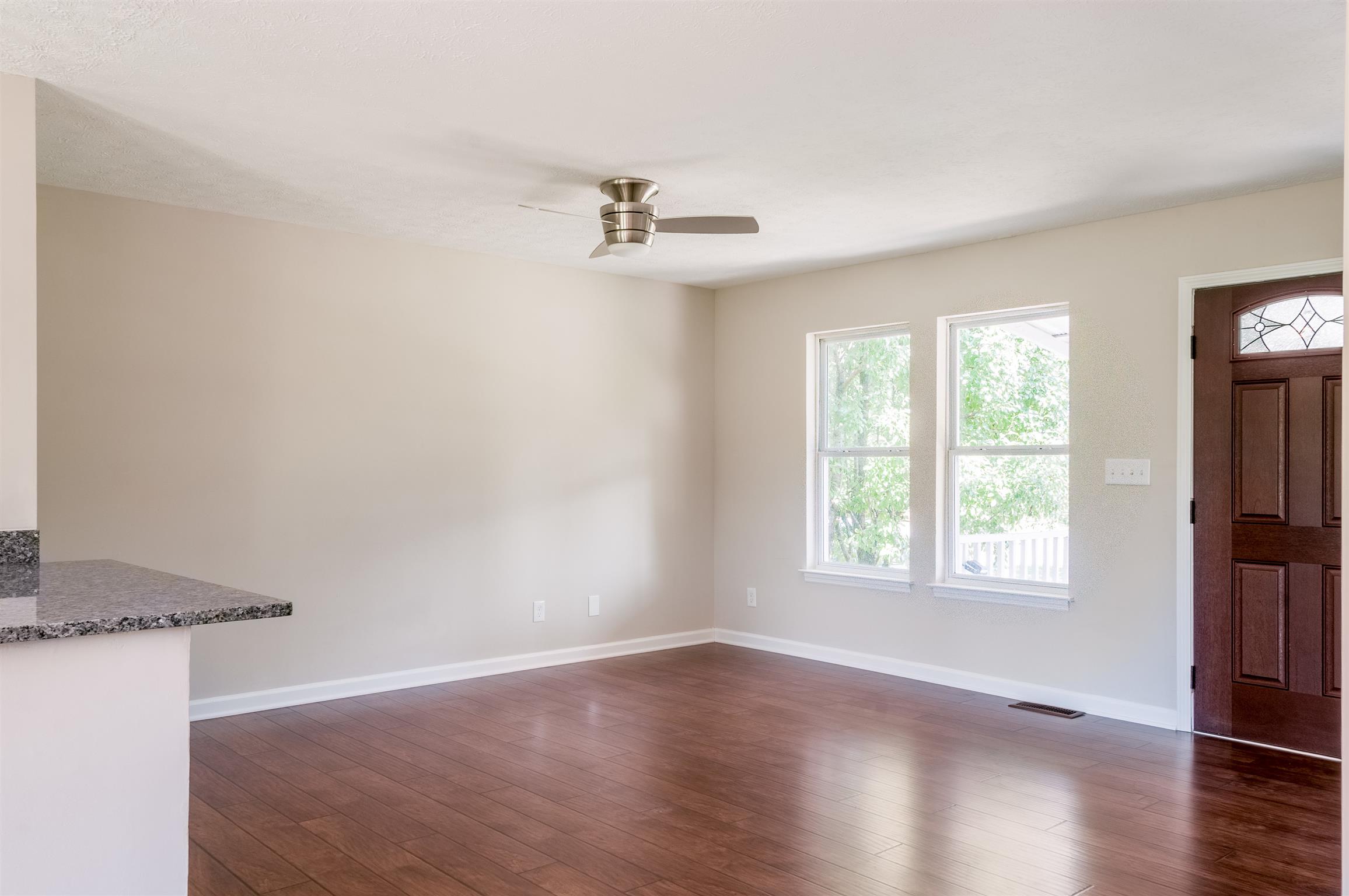 508 Curd Road Mount Juliet, TN 37122 - Photo 2 of 14 an empty room with wooden floor cabinet and windows